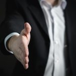 Man reaching out hand for a hand shake. How To Sell B2B